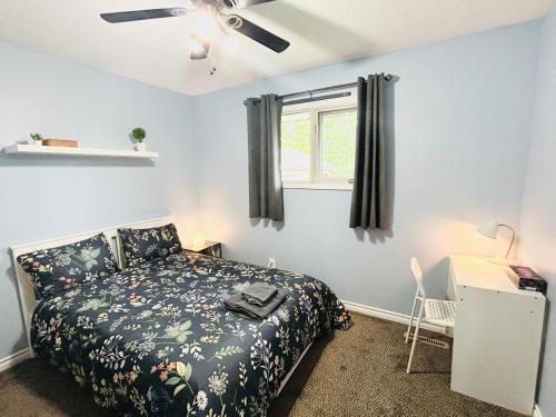 a bedroom with a bed and a ceiling fan at Fully Furnished, Contractor-friendly,4Beds, Free Parking&Laundry, Corporate Housing in Thompson