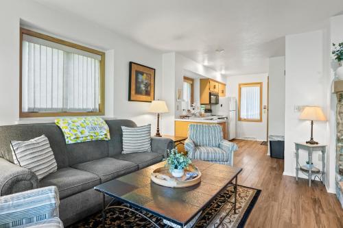 a living room with a couch and a table at Holiday by the Bay Unit A-4 by Simple Life Rentals in Fish Creek