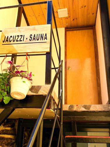 a door and a potted plant on a balcony at Andenes del Inca Hotel in Ollantaytambo