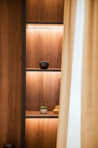 a cupboard with a plant in a bowl on it at Sonrisa Apartments Kolasin in Kolašin