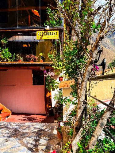 a building with a sign that reads restaurant at Andenes del Inca Hotel in Ollantaytambo