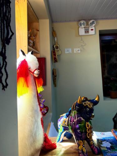 a room with two stuffed animals on a table at Andenes del Inca Hotel in Ollantaytambo