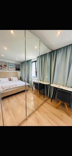 a bedroom with a bed and a mirror at House in Pezinok with swimming pool, Bratislava in Pezinok