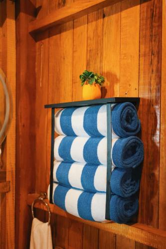 a stack of blue and white towels on a shelf at Bolontikú in Bacalar