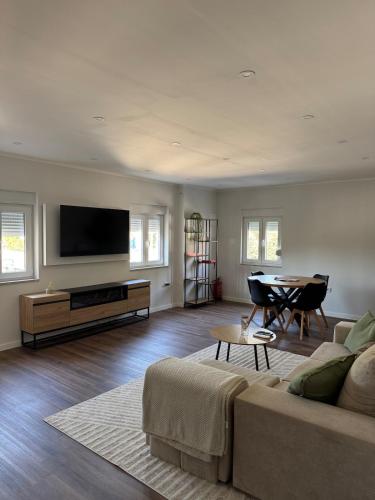 a living room with a couch and a table at Casa Carvalho in Peso da Régua