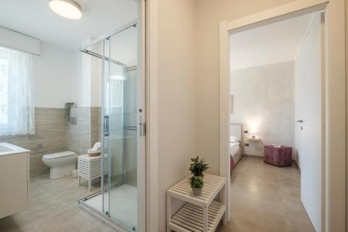 Quartu Sant'ElenaにあるIris Sun Suite - Comfort & Dreamy Beachesのバスルーム(ガラス張りのシャワー、トイレ付)
