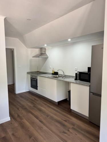 a kitchen with white cabinets and a counter top at Casa Carvalho in Peso da Régua