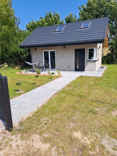 a house with a solar roof on top of it at Domek na Uboczu in Lubocino