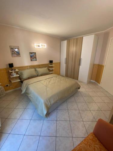 a bedroom with a large bed in a room at Maison Prestige in Monfalcone