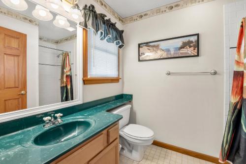 a bathroom with a sink and a toilet at SeaClusion in Corolla