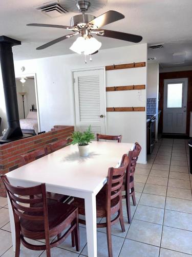 a dining room with a white table and chairs at Centrally located Cozy Mid-Century Home in McComb