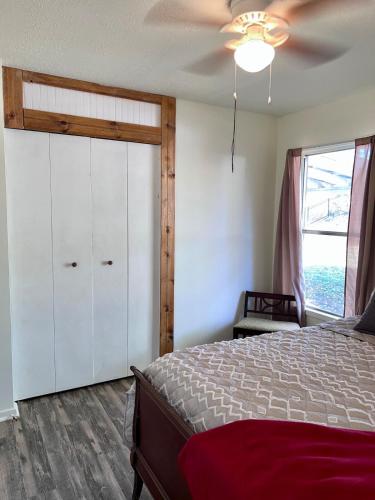 a bedroom with a bed and a ceiling fan at Centrally located Cozy Mid-Century Home in McComb