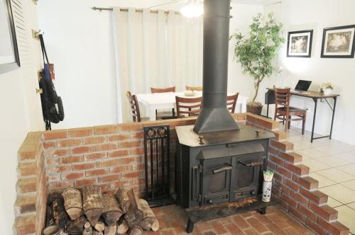 a brick fireplace with a stove in a living room at Centrally located Cozy Mid-Century Home in McComb