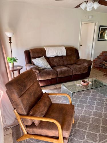 a living room with a couch and a chair at Centrally located Cozy Mid-Century Home in McComb