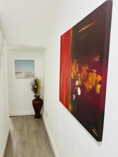 a painting hanging on a wall in a room at Sterling Bed & Breakfast in Ilford