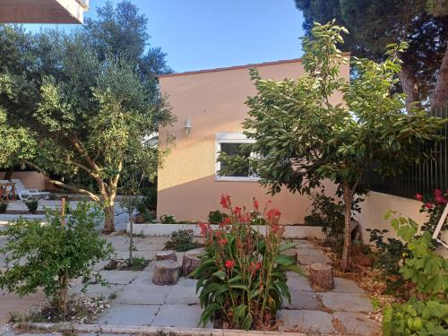 a garden in front of a house with trees and flowers at Garden house in Cascais in Cascais
