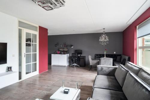 a living room with a couch and a table at A Cozy and Nice Furnished Room in Shared Modern Apartment in Barendrecht