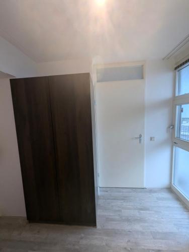 an empty room with a closet and a door at A Cozy and Nice Furnished Room in Shared Modern Apartment in Barendrecht