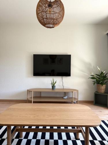 a living room with a coffee table and a flat screen tv at Gorgeous Modern Mountain View Flat in Täsch in Täsch