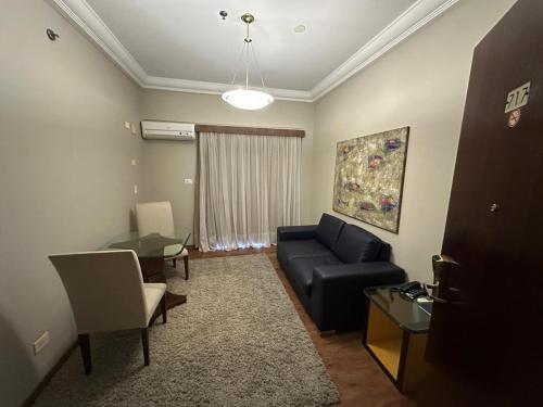 a living room with a couch and a table at ibis Styles Presidente Prudente Portal D'Oeste in Presidente Prudente