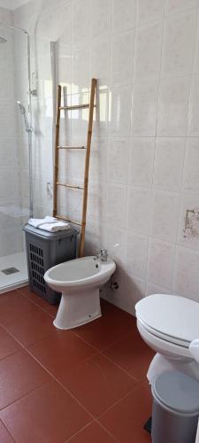 a bathroom with a toilet and a sink and a shower at Chez Tronqueira 43 in Faja Grande