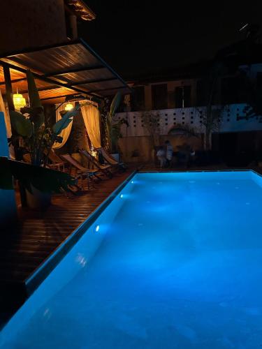 a blue swimming pool in a house at night at Casa Palma Boutique Hotel in Vlorë