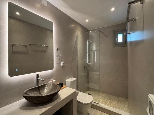 a bathroom with a sink and a shower at BLUE VILLA Sifnos in Kamarai