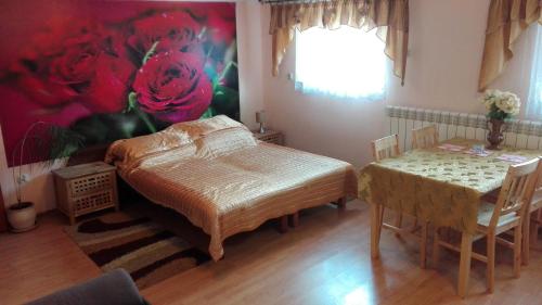 a bedroom with a bed and a table and chairs at Agroturystyka Kwatery pracownicze Noclegi Rybno Mazury in Rybno