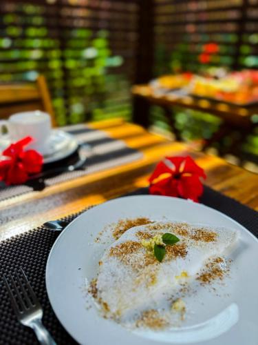 a plate of food sitting on a table at Pousada HAI in Fernando de Noronha
