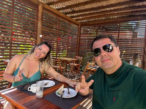 a man and a woman sitting at a table at Pousada HAI in Fernando de Noronha