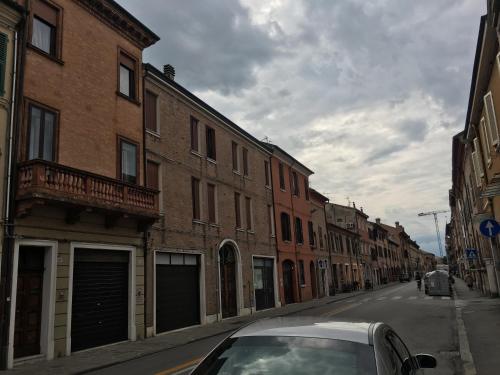 a car parked on a city street with buildings at Dimora '800 in Ferrara
