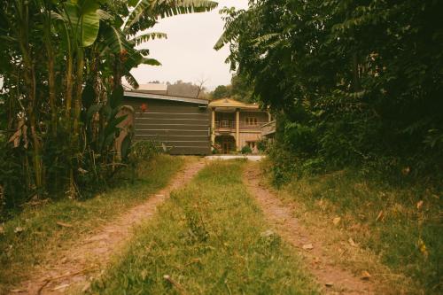 a dirt road in front of a house at The Mountain Retreat, Muzaffarabad - Families Only in Muzaffarabad