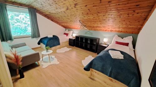 a bedroom with a bed and a couch and a chair at Olmhaus in Obergösel