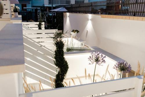 a white fence with plants on it at Geranium B&B in Bitonto