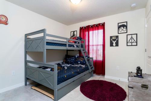 a bedroom with a bunk bed and a red curtain at Luxury 5 Bed Townhome with Private Pool - Solterra - 7598 OS in Davenport