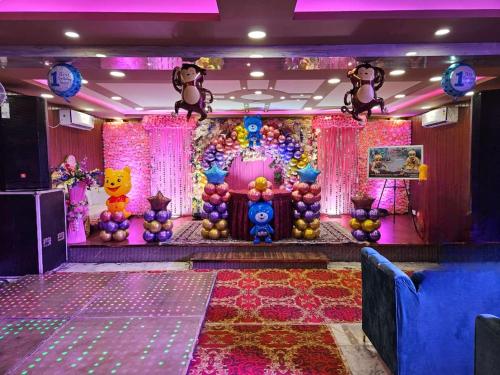 a room with a stage with a bunch of decorations at The ARL Hotels & Banquets in Patna