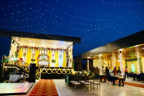 a stage in a building with people standing around it at The ARL Hotels & Banquets in Patna
