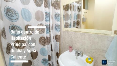 a bathroom with a shower curtain and a sink at FRENTE AL MAR en SAN MIGUEL Apartamento LIMA CHECK IN in Lima