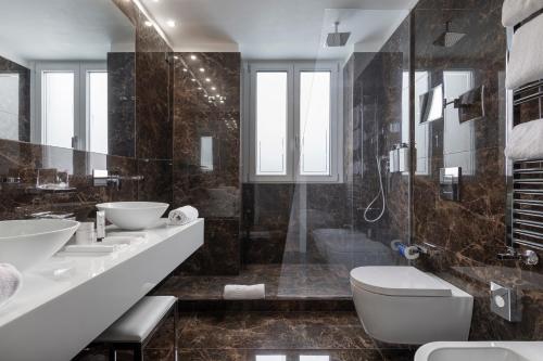 a bathroom with two sinks and a toilet and a tub at LHP River Club in Florence