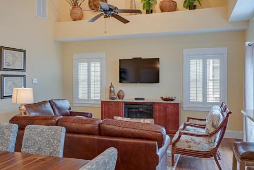a living room with a couch and a tv at Seaside Serenity in Corolla