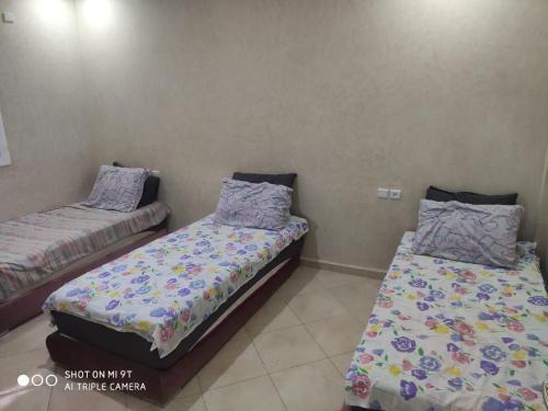 a room with two beds in a room at Palma Aglou in Tiznit
