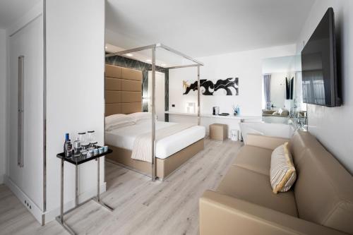 a bedroom with a canopy bed and a couch at LHP River Club in Florence