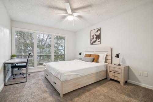 a bedroom with a bed and a desk and window at The Trails M262 I Spacious 2 Bed 2 Bath in Gainesville
