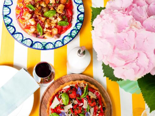 a table with two plates of food and a pizza at Moulin de Saint Jacques 