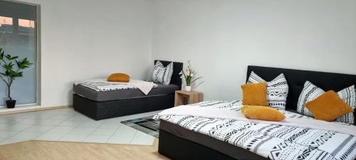 a bedroom with a bed and a ottoman at Central apartment in LINZ in Linz