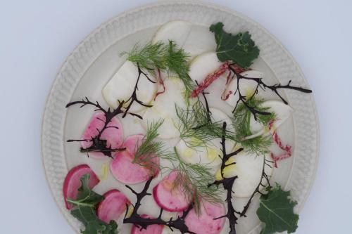 a plate of food with plants on it at 柿畑の宿 guesthouse next to the persimmon orchard in Katsuragi