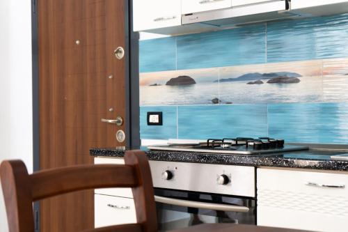 a kitchen with a stove and a counter top at Liora Seaview Apartments in Shëngjin
