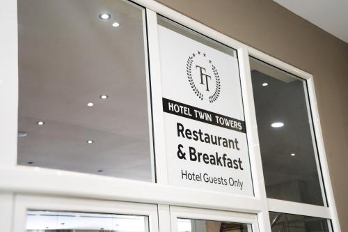 a sign for a hotel turn towers restaurant and breakfast at Liora Seaview Apartments in Shëngjin