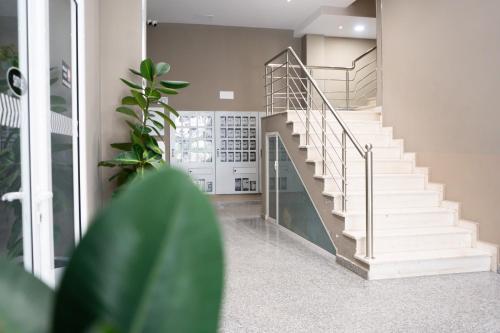 a staircase in a home with a white stair case at Liora Seaview Apartments in Shëngjin