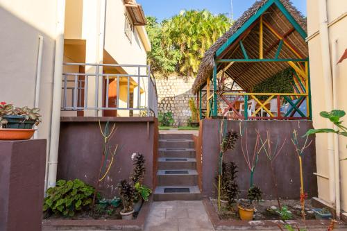 a building with a staircase and some plants at Studio Standard - AMI APPARTHOTEL in Tôlagnaro